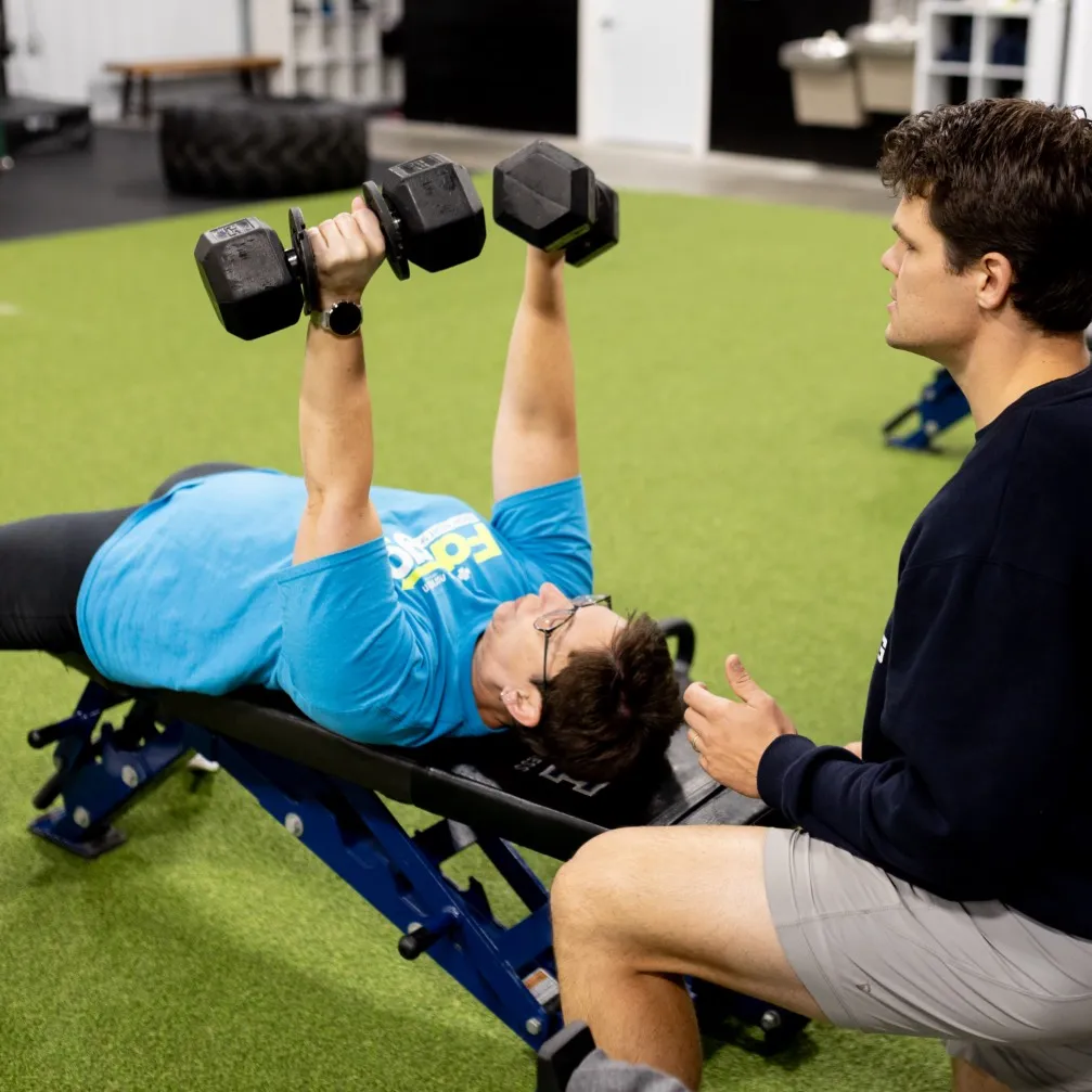 Member performing bench press